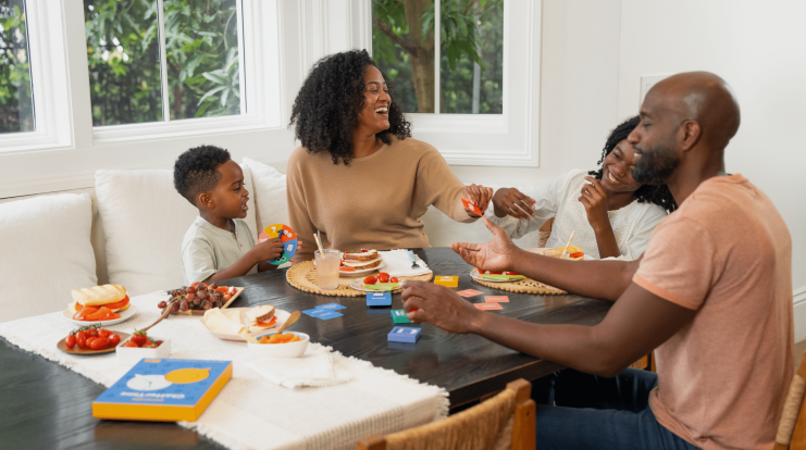 Family playing pennycake games at the kitchen table
